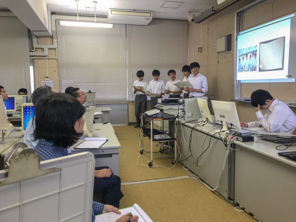 緑峰高校の生徒のプレゼンテーションを受ける先生と民間企業の社長の様子